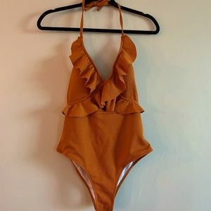 New, never worn one piece swimsuit with ruffle